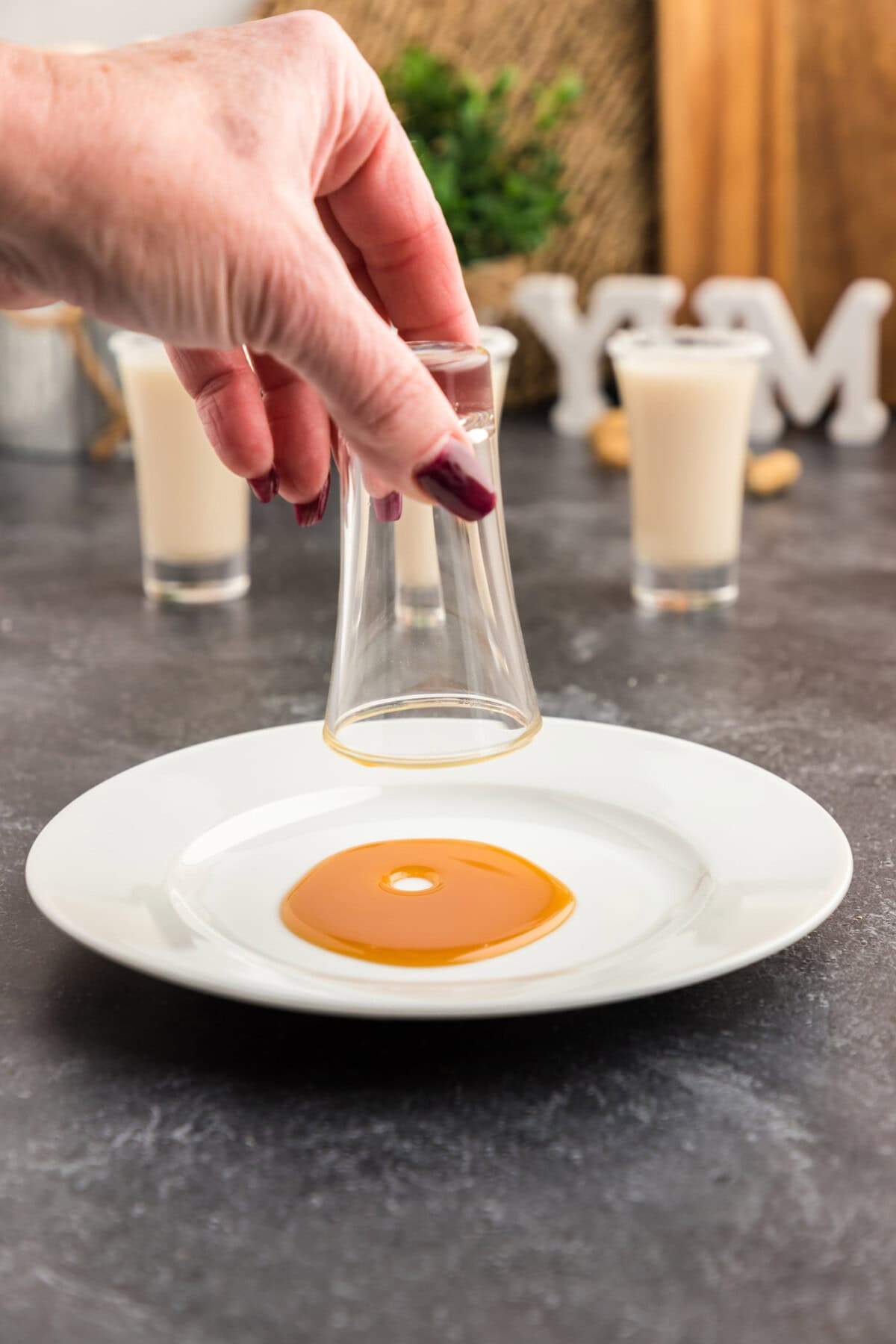 dipping shot glass into caramel