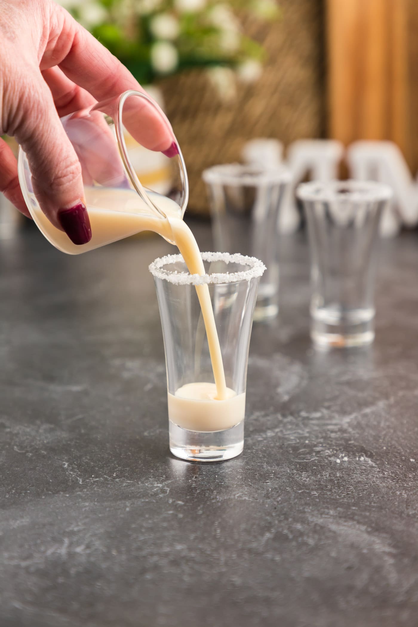 pouring rum chata into shot glass