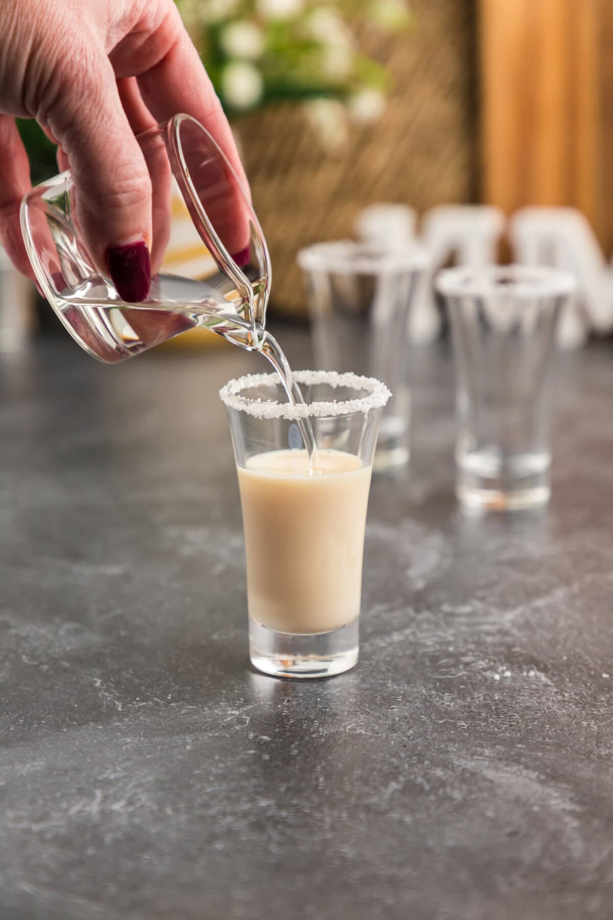 pouring butterscotch schnapps into shot glass