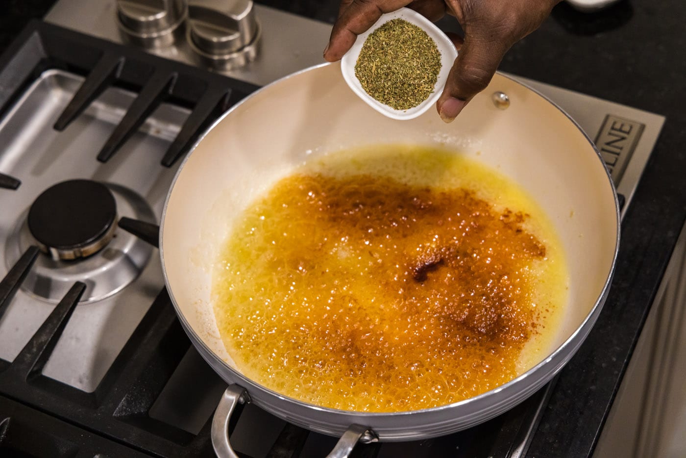 adding seasoning to butter mixture in skillet