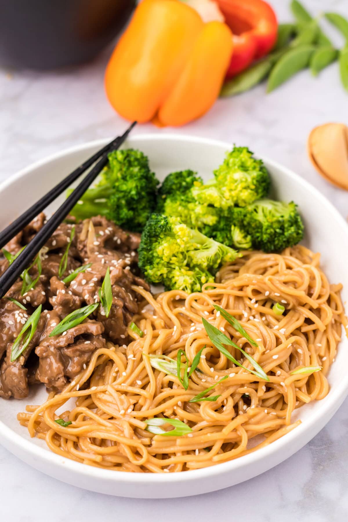 Teriyaki Noodles plated with broccoli and beef teriyaki