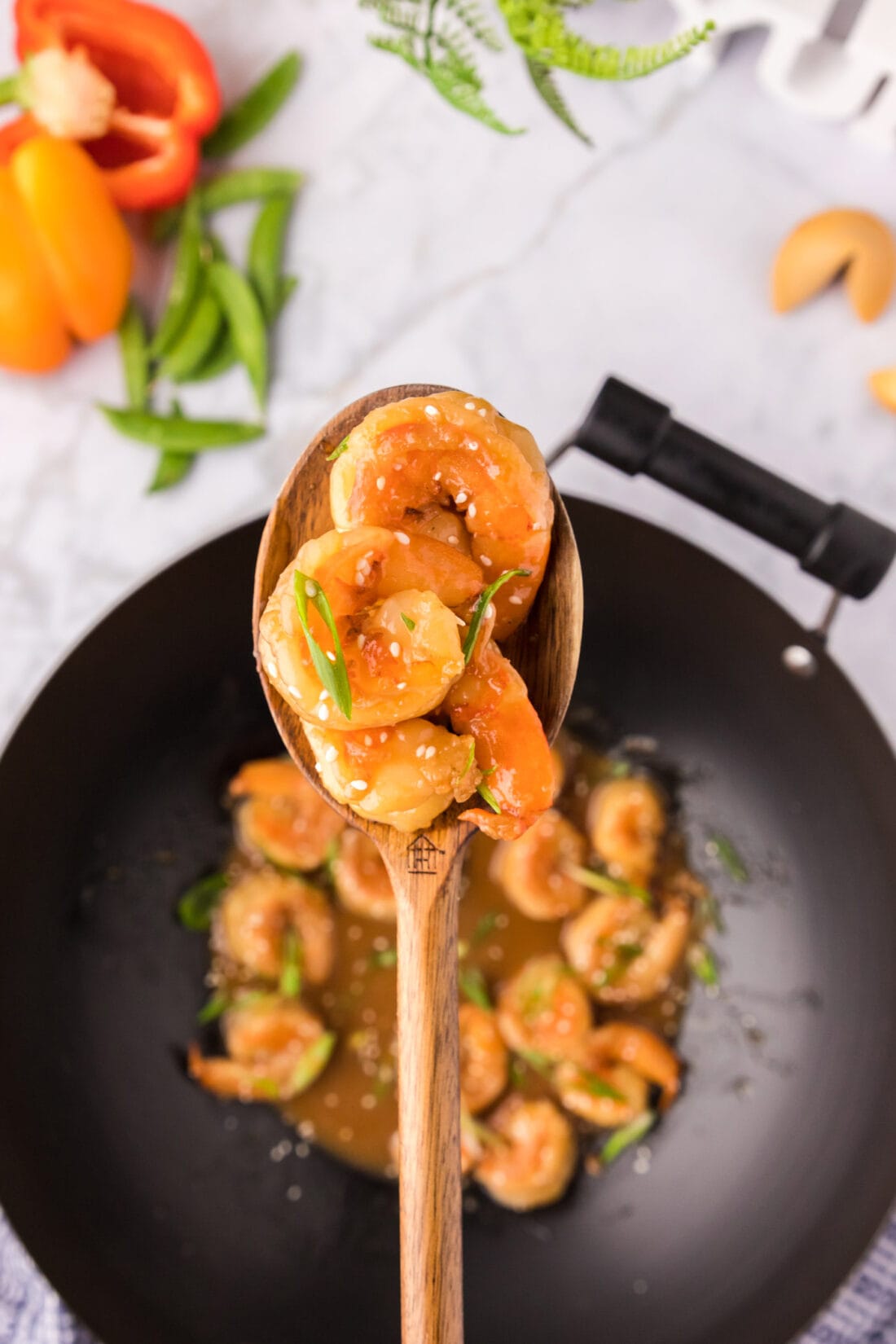 Spoonful of Teriyaki Shrimp held above a wok