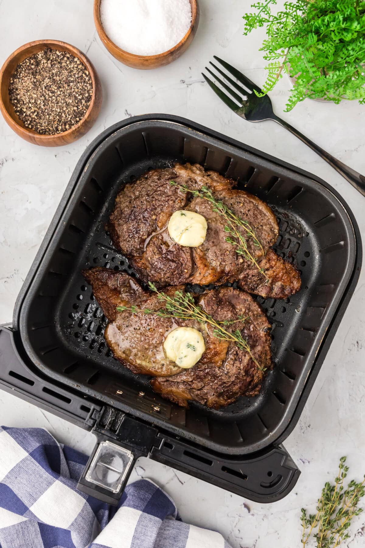 Two cooked steaks in an Air Fryer