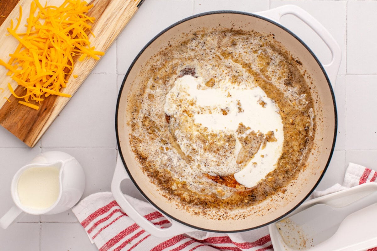 heavy whipping cream added to skillet with butter mixture