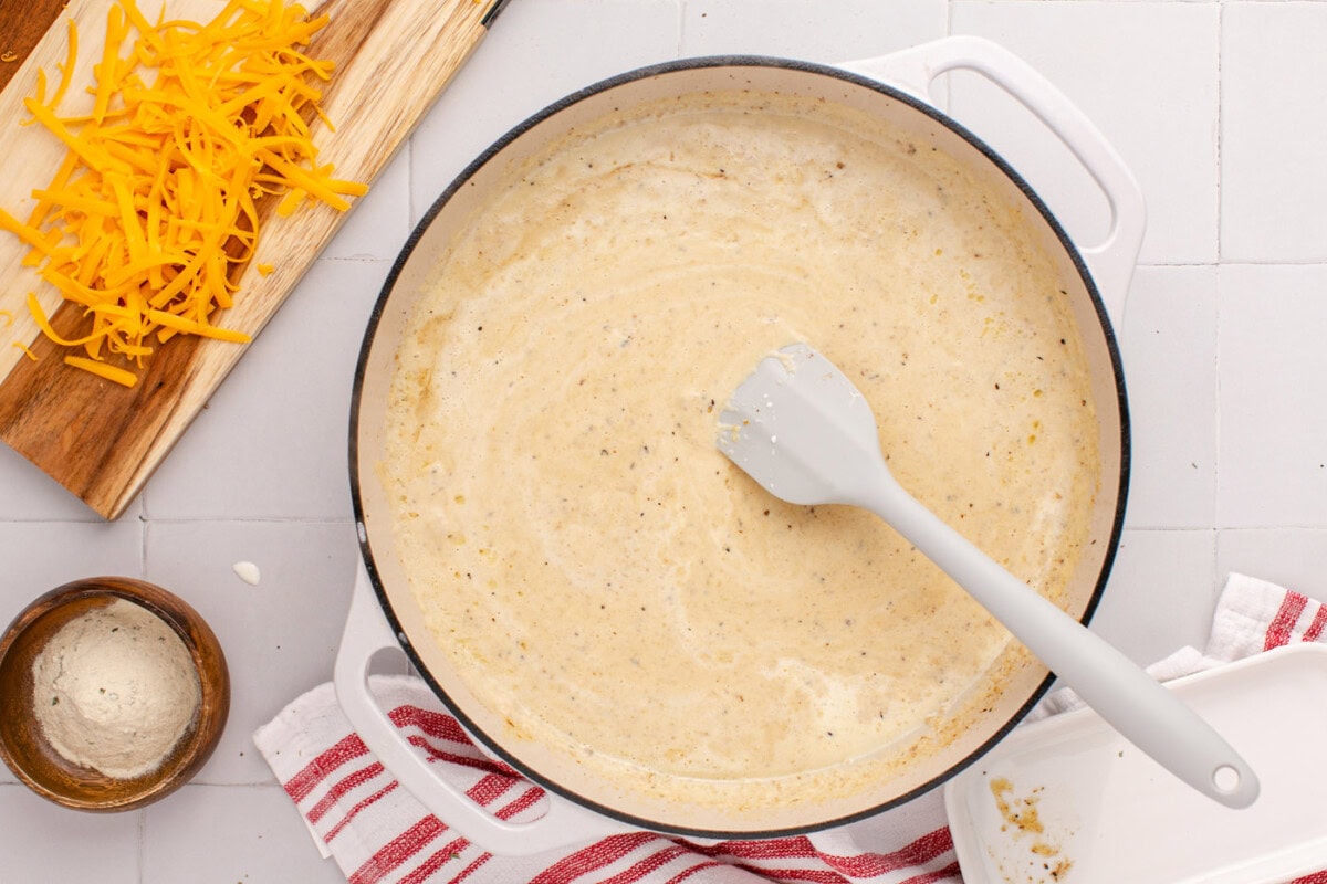 rubber spatula in pan of creamy ranch sauce