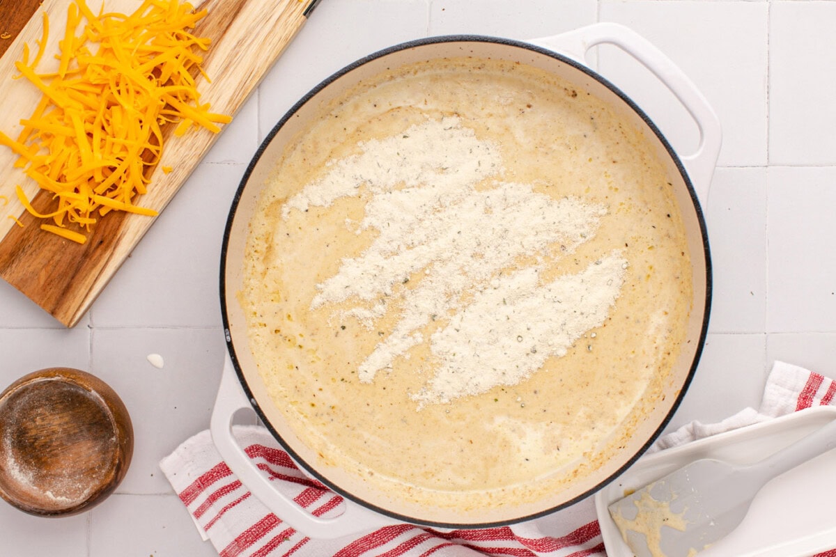 ranch seasoning mix added to cream sauce in skillet
