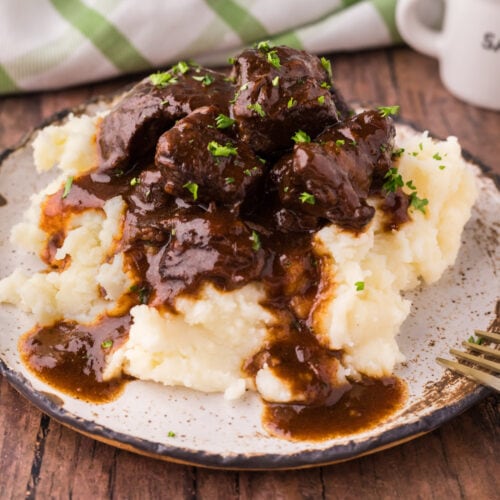Close up photo of Beef Tips and Gravy served over mashed potatoes