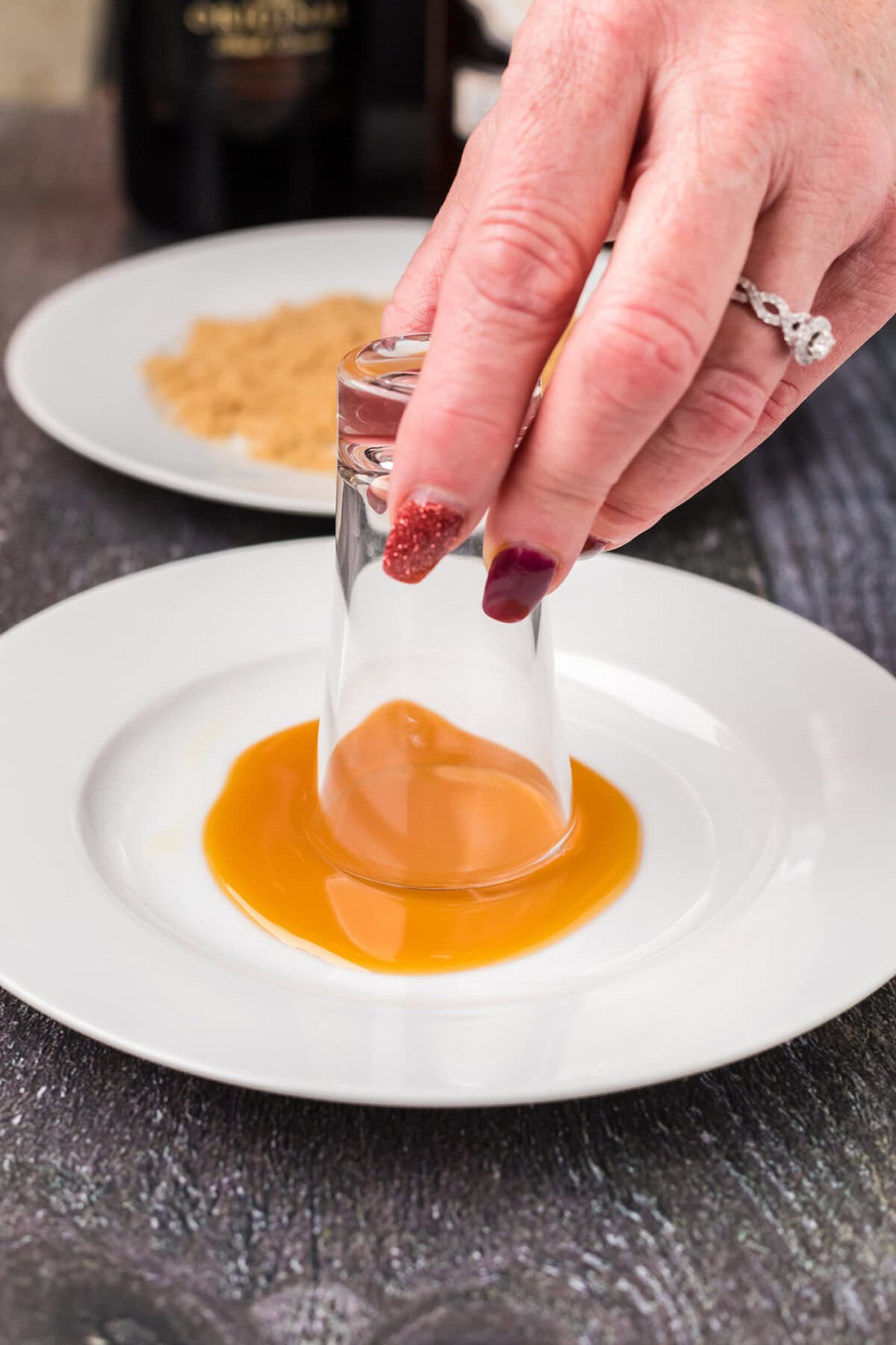 dipping shot glass into caramel