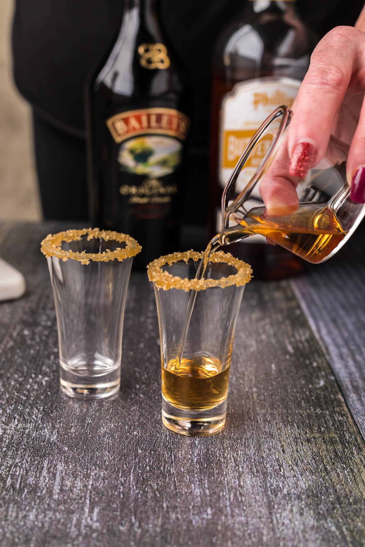 pouring butterscotch schnapps into shot glass