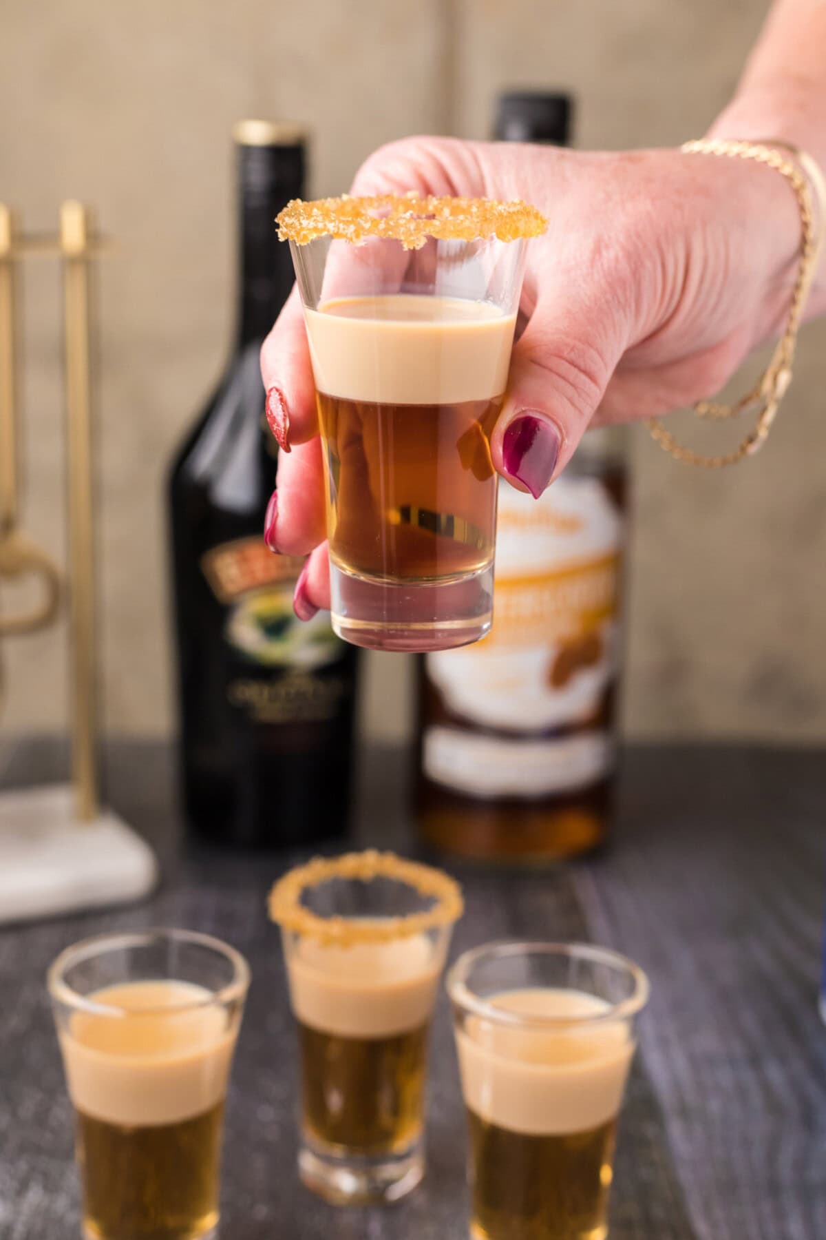 Hand holding up a Buttery Nipple Shot