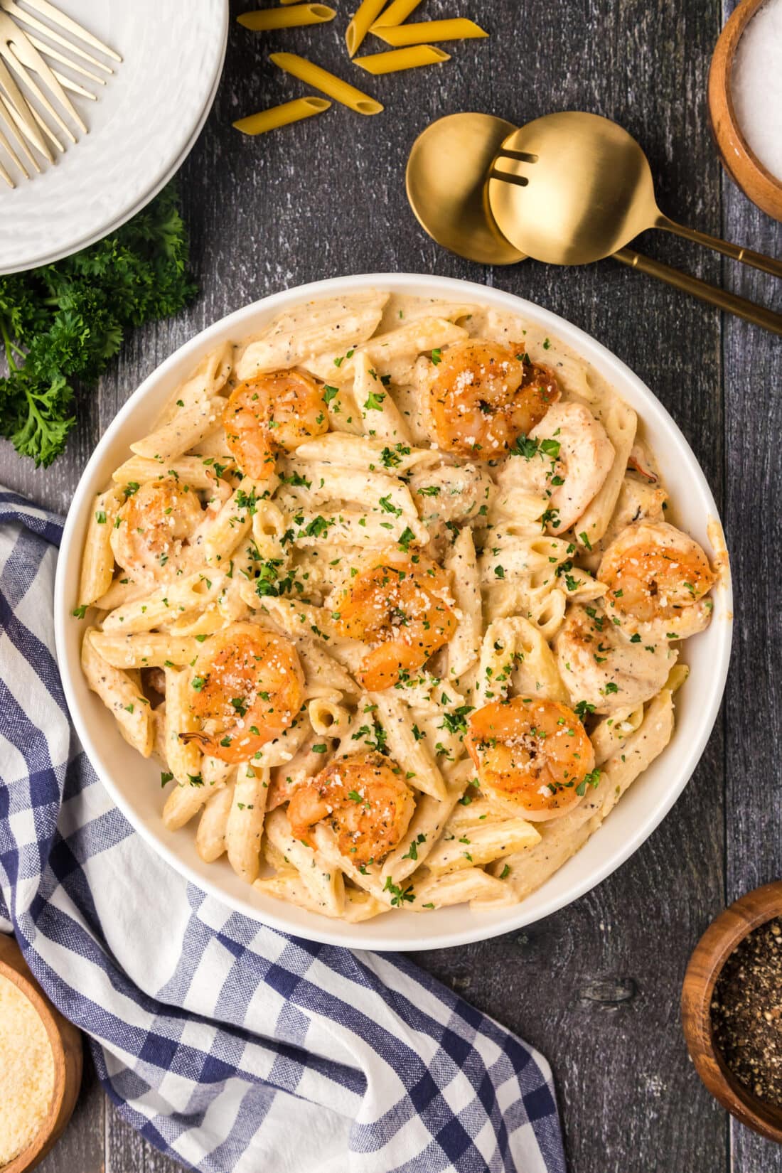 Bowl of Cajun Shrimp Pasta with serving spoons on the side