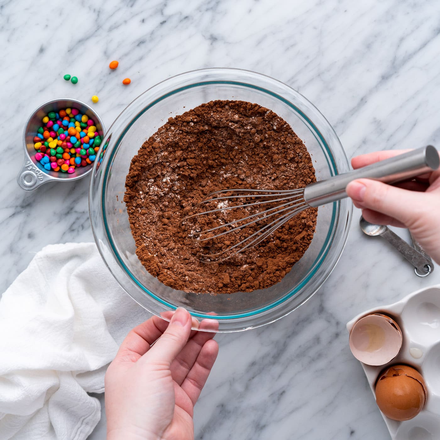 whisking flour, cocoa powder, and salt in a bowl