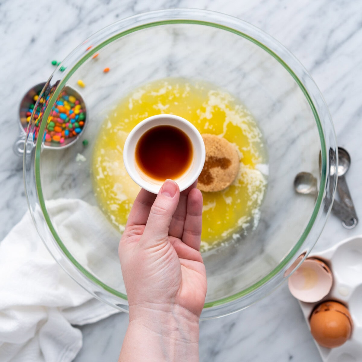 vanilla over sugar, oil, and butter mixture in a bowl