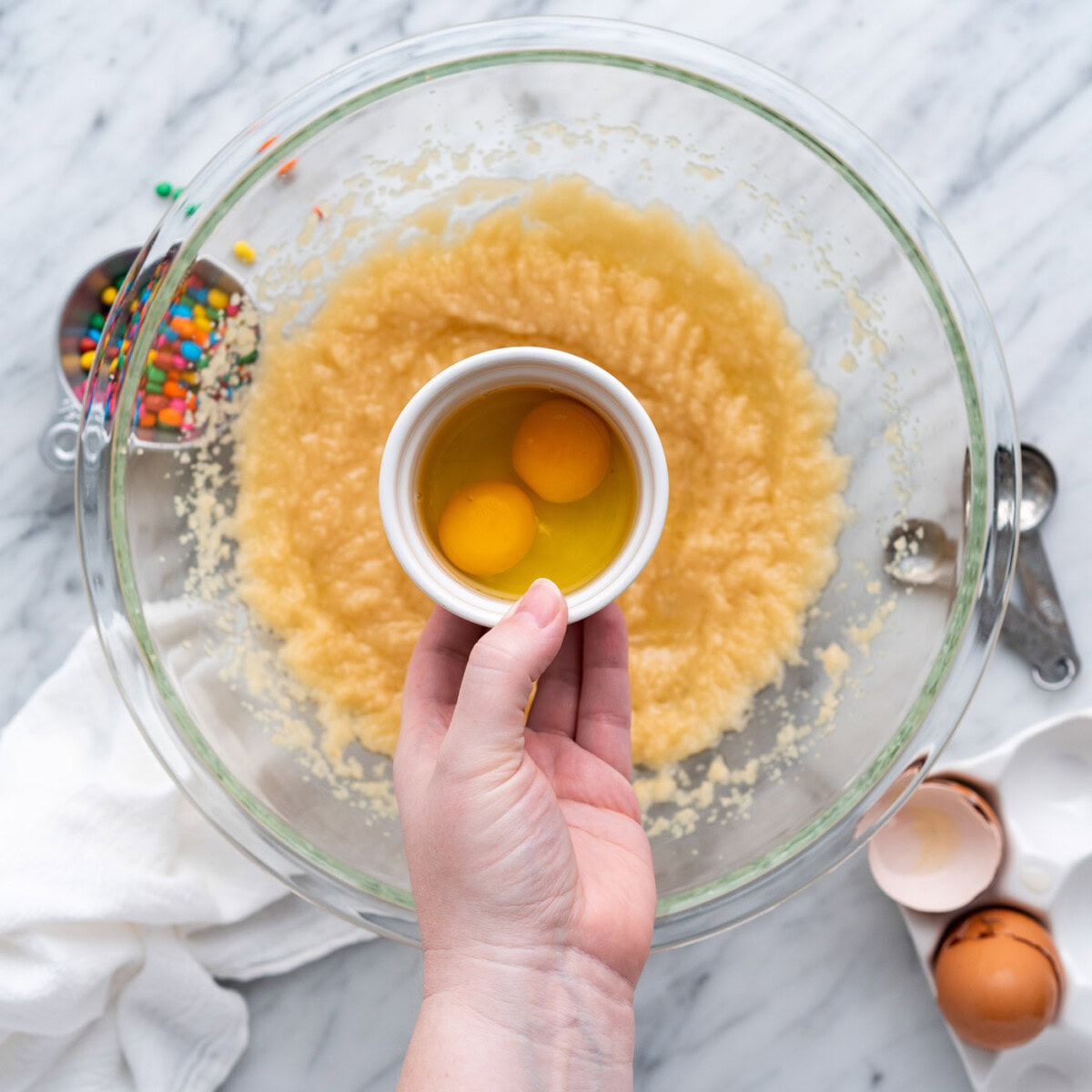 adding eggs to brownie wet batter