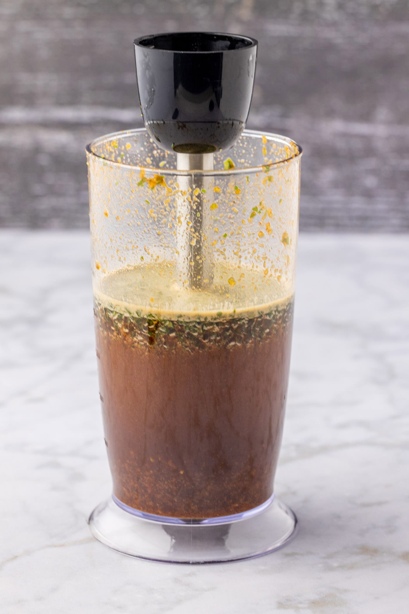 blitzing marinde ingredients with an immersion blender