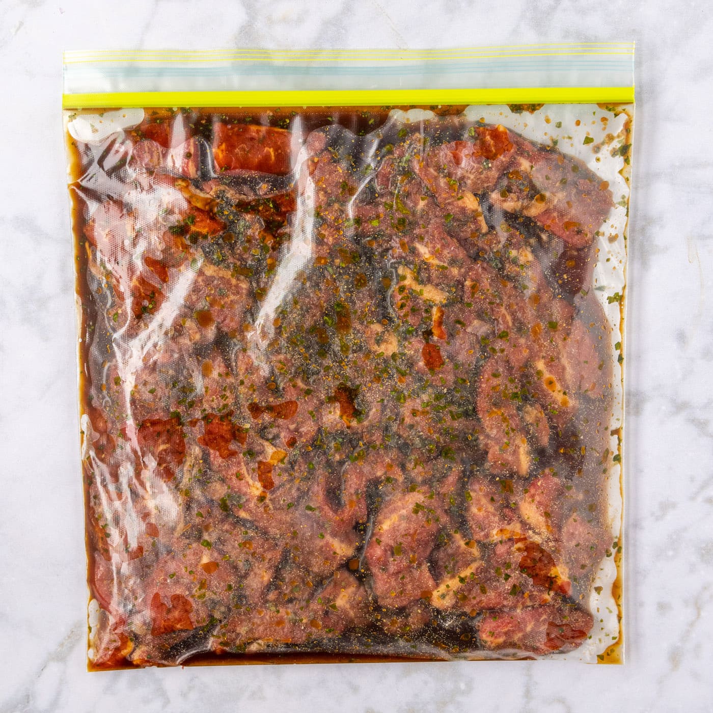 marinating beef strips in a large zip top bag