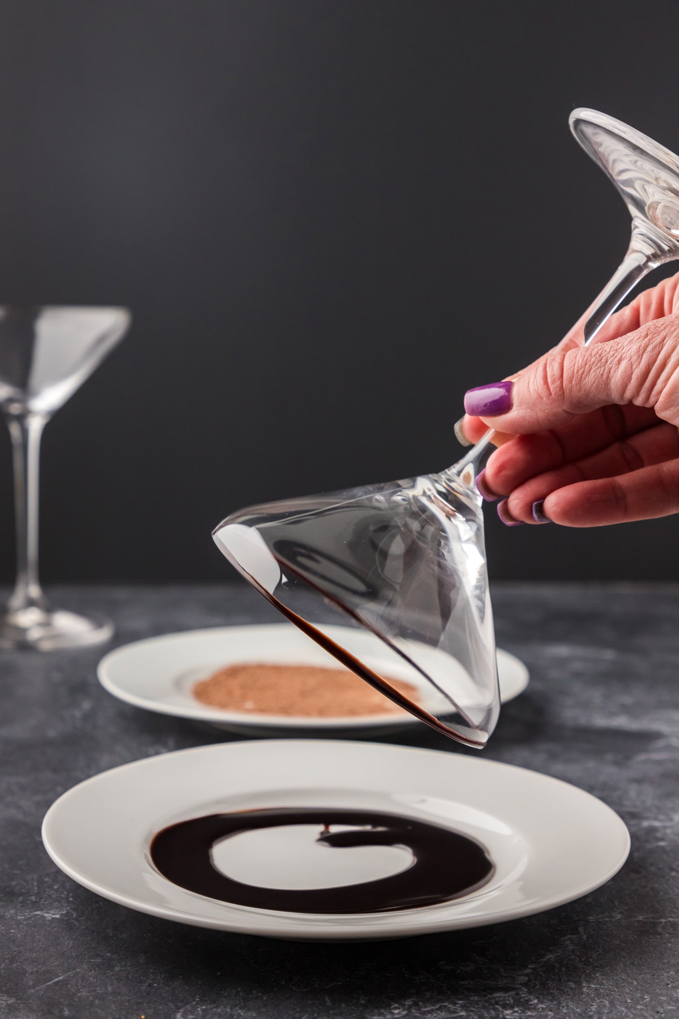 dipping rim of cocktail glass in chocolate syrup
