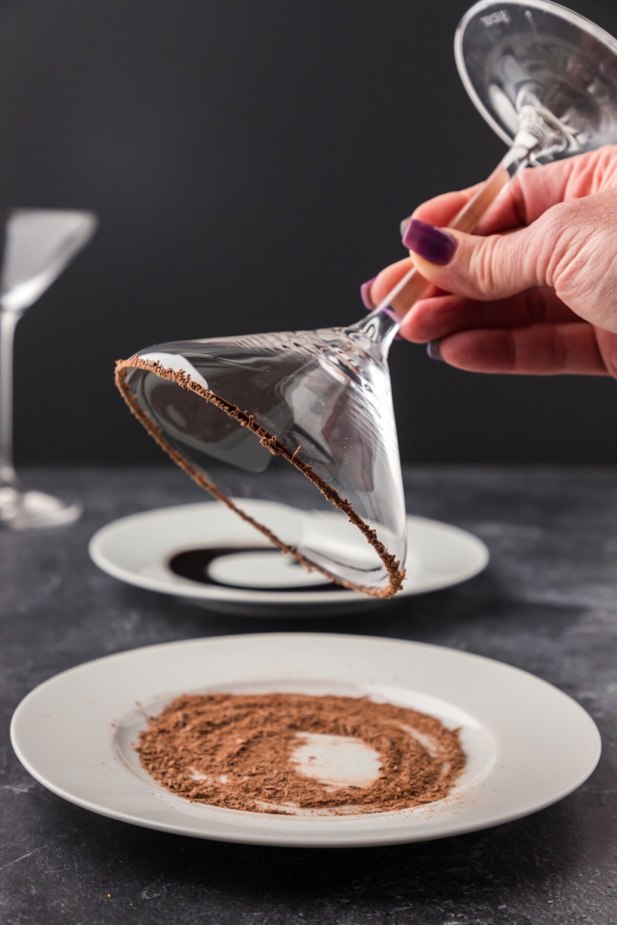 dipping rim of chocolate glass in shaved chocoalte