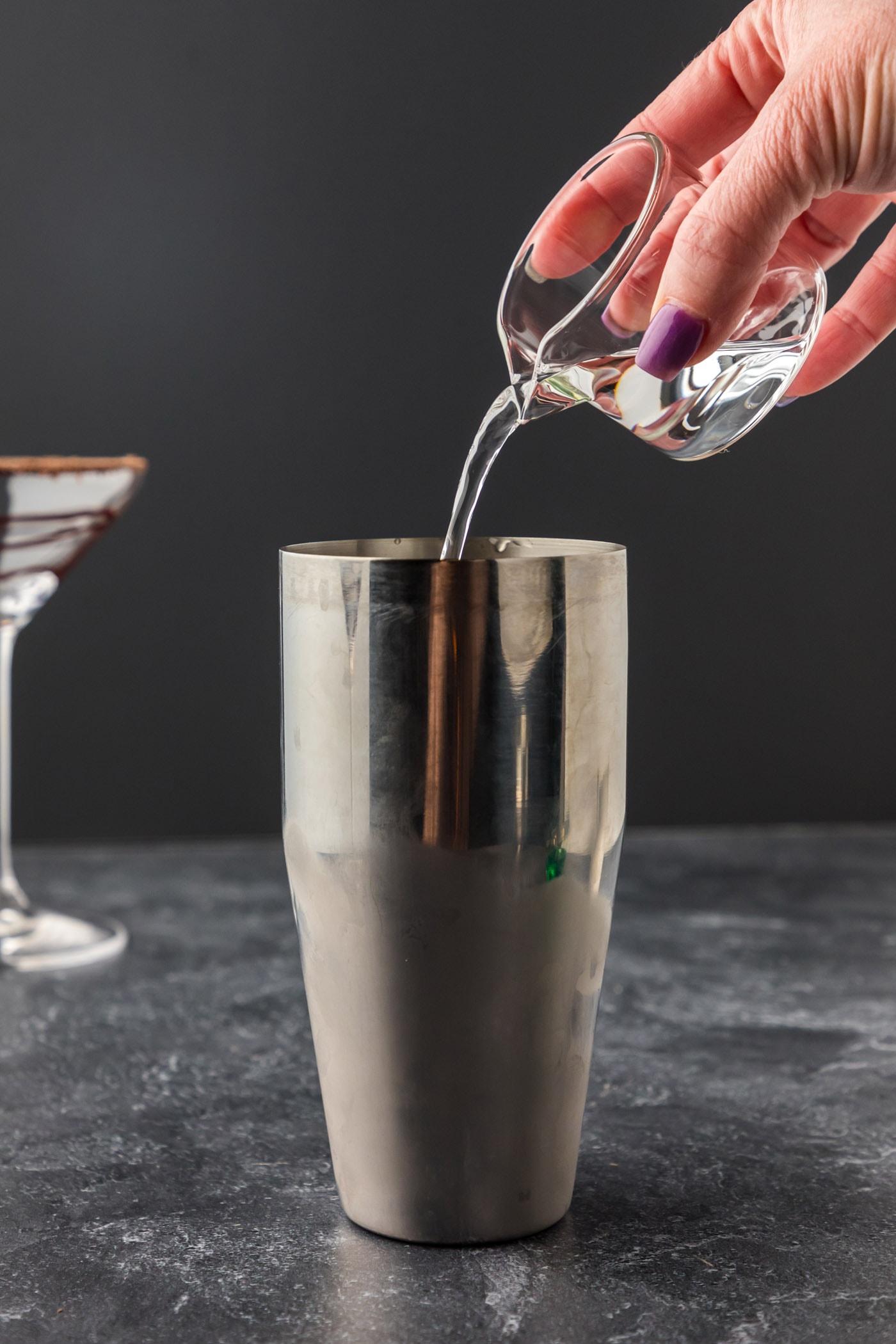 adding creme de cacao to cocktail shaker