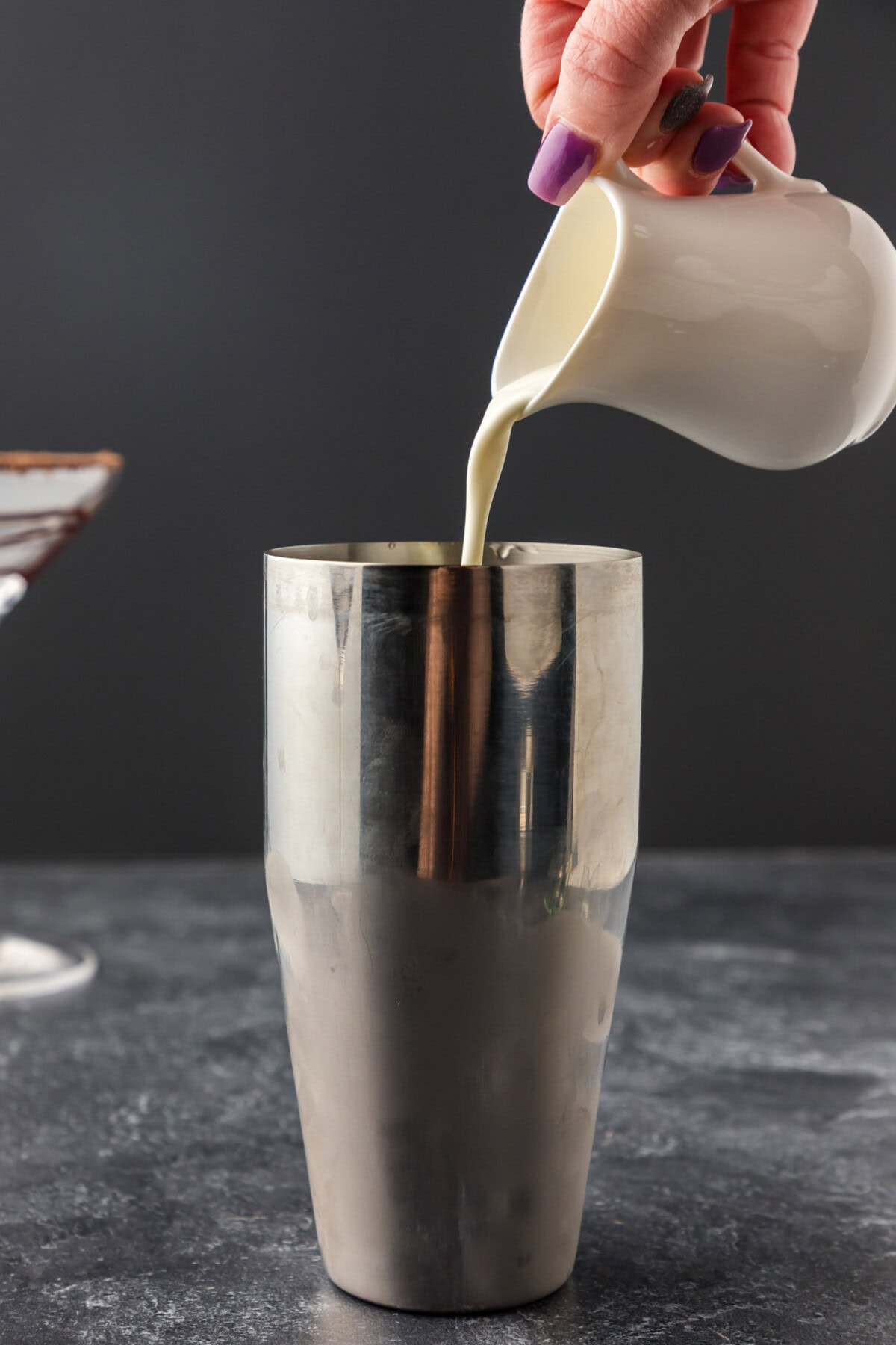 pouring heavy cream into cocktail shaker