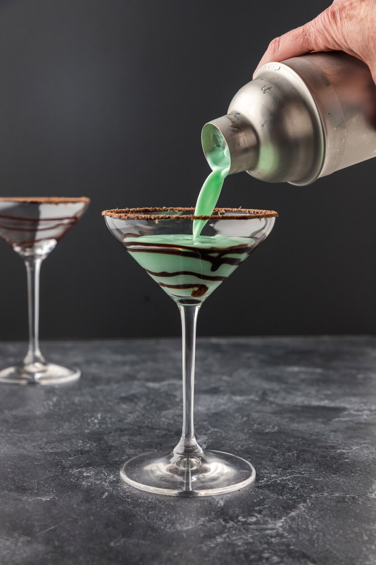 pouring grasshopper cocktail into martini glass