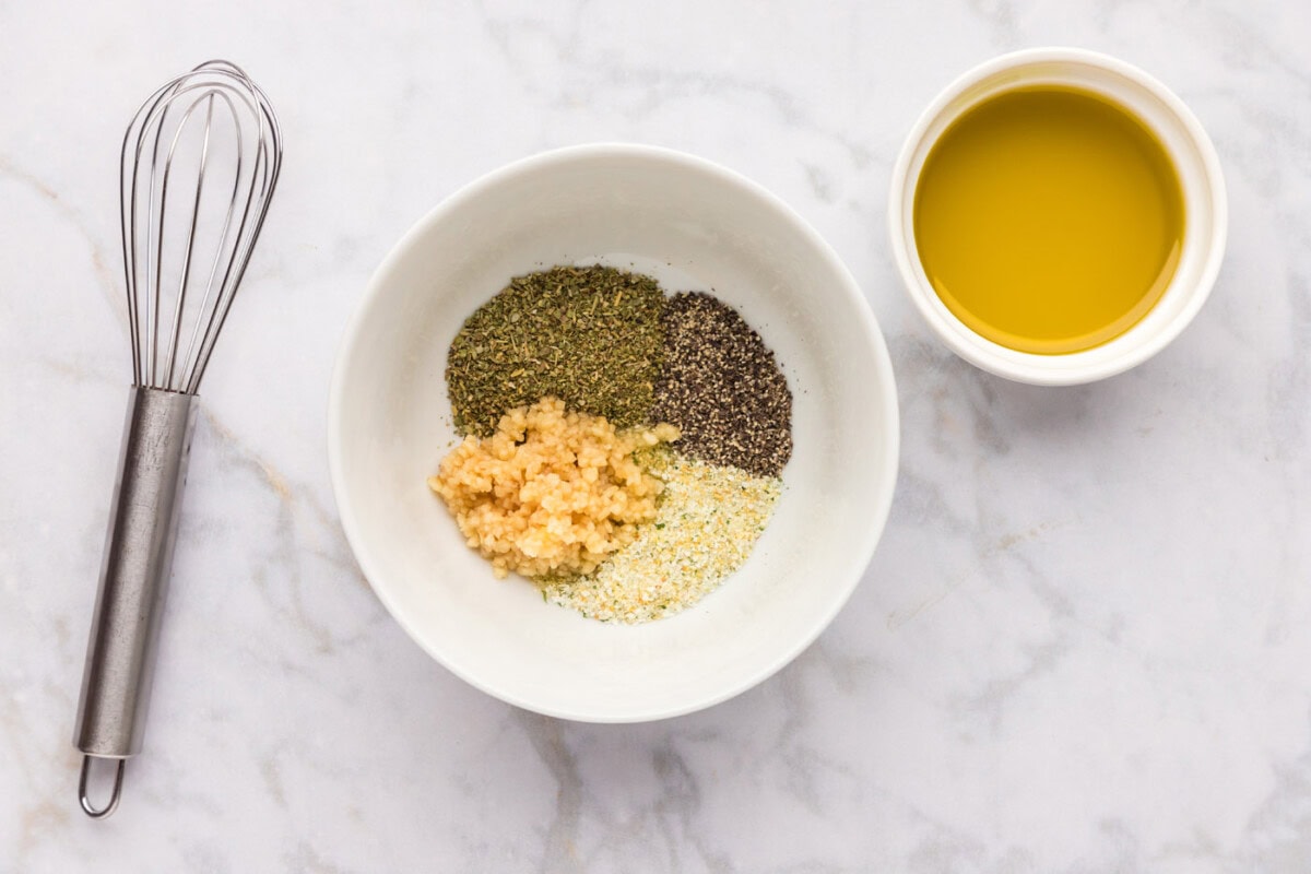 seasonings for zucchini in a bowl with garlic