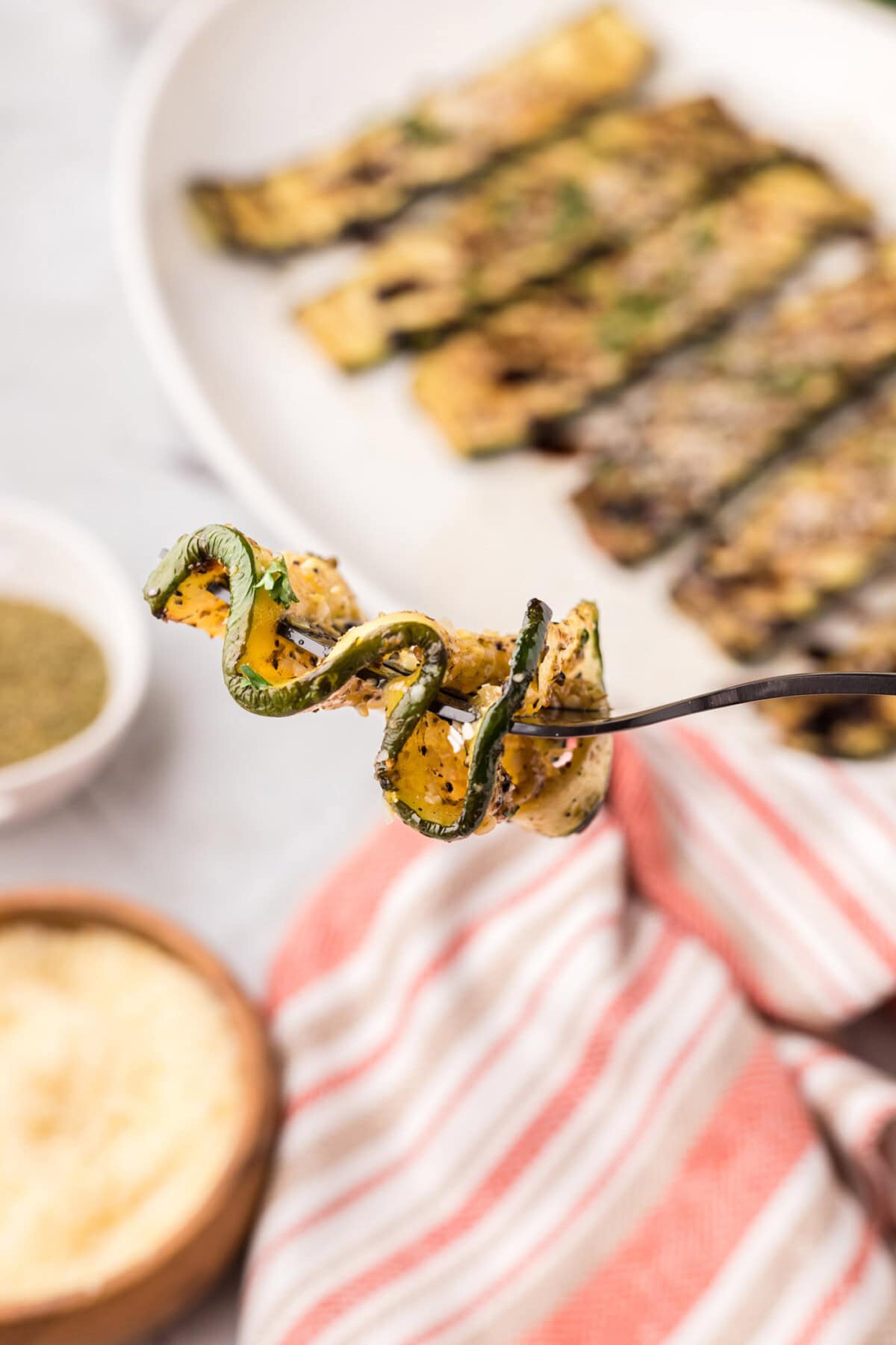 Piece of Grilled Zucchini zig-zagged on a fork