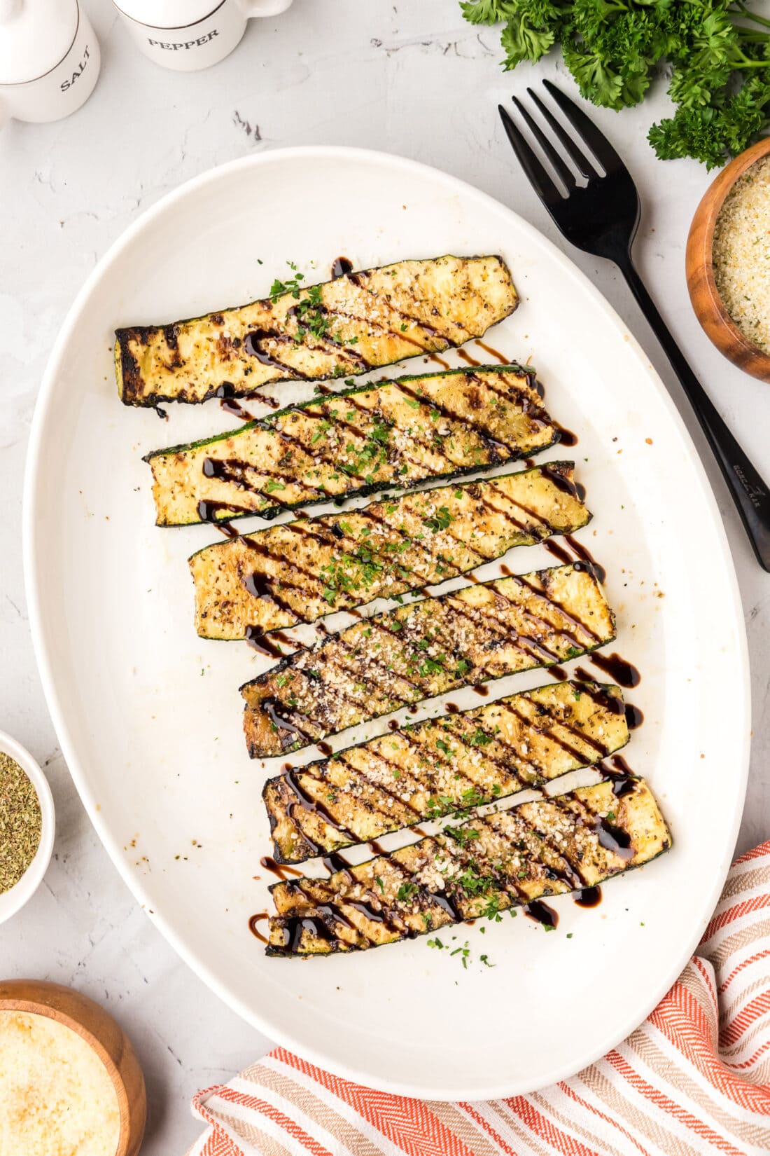 Grilled Zucchini on a platter topped with balsamic glaze
