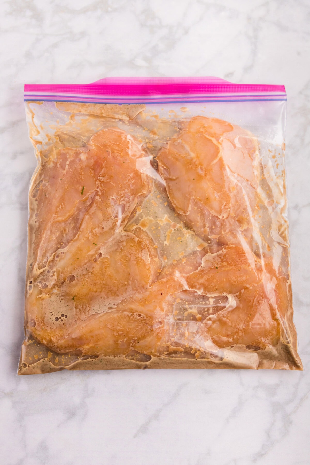 chicken breasts marinating in honey garlic sauce