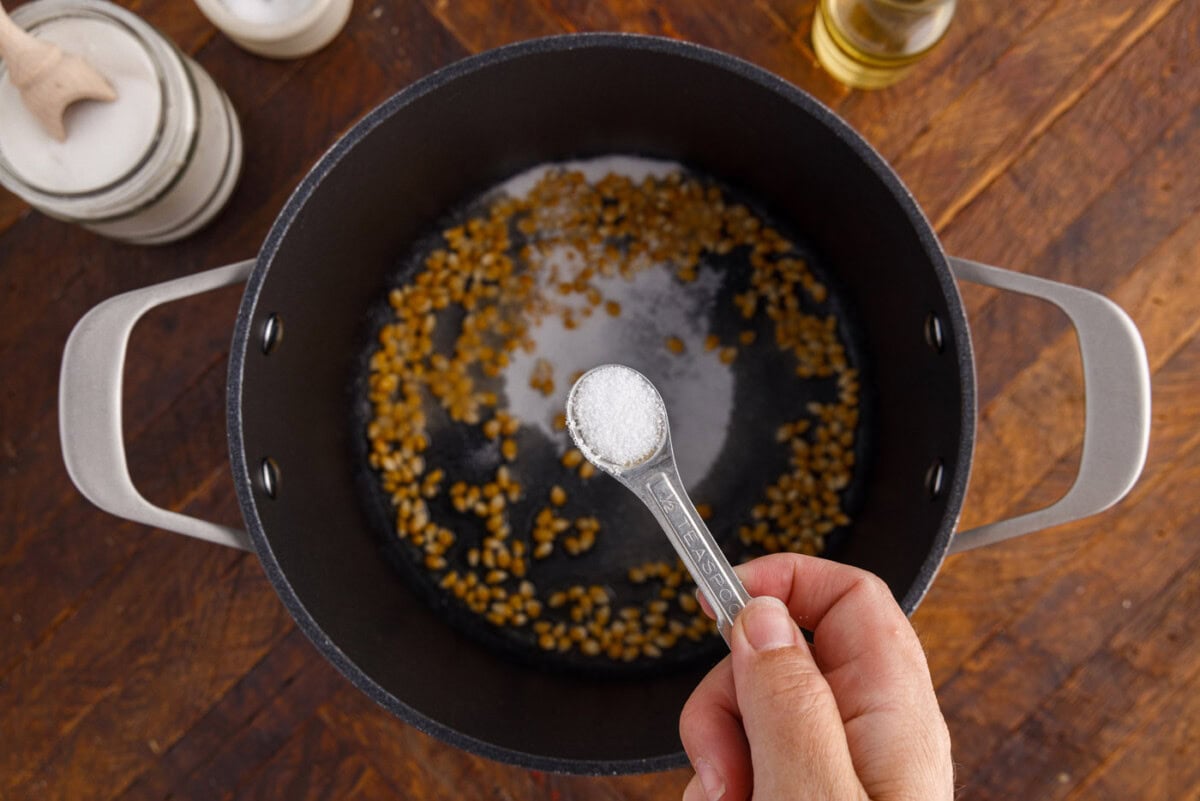 adding salt to sugar and corn kernels
