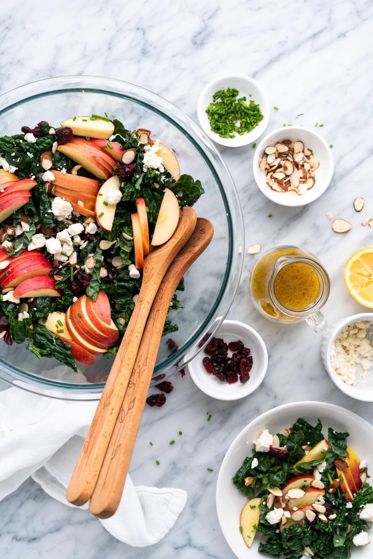 Bowl of kale salad with Lemon Salad Dressing and other topping on the side