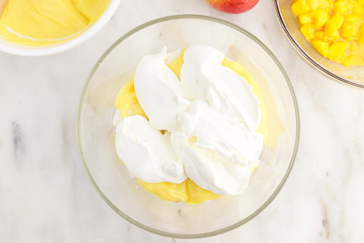 whipped cream layer over pudding and angel food cake