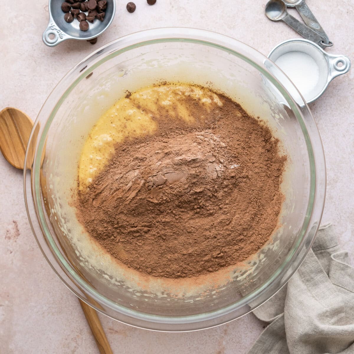 adding dry ingredients to wet ingredients for brownies