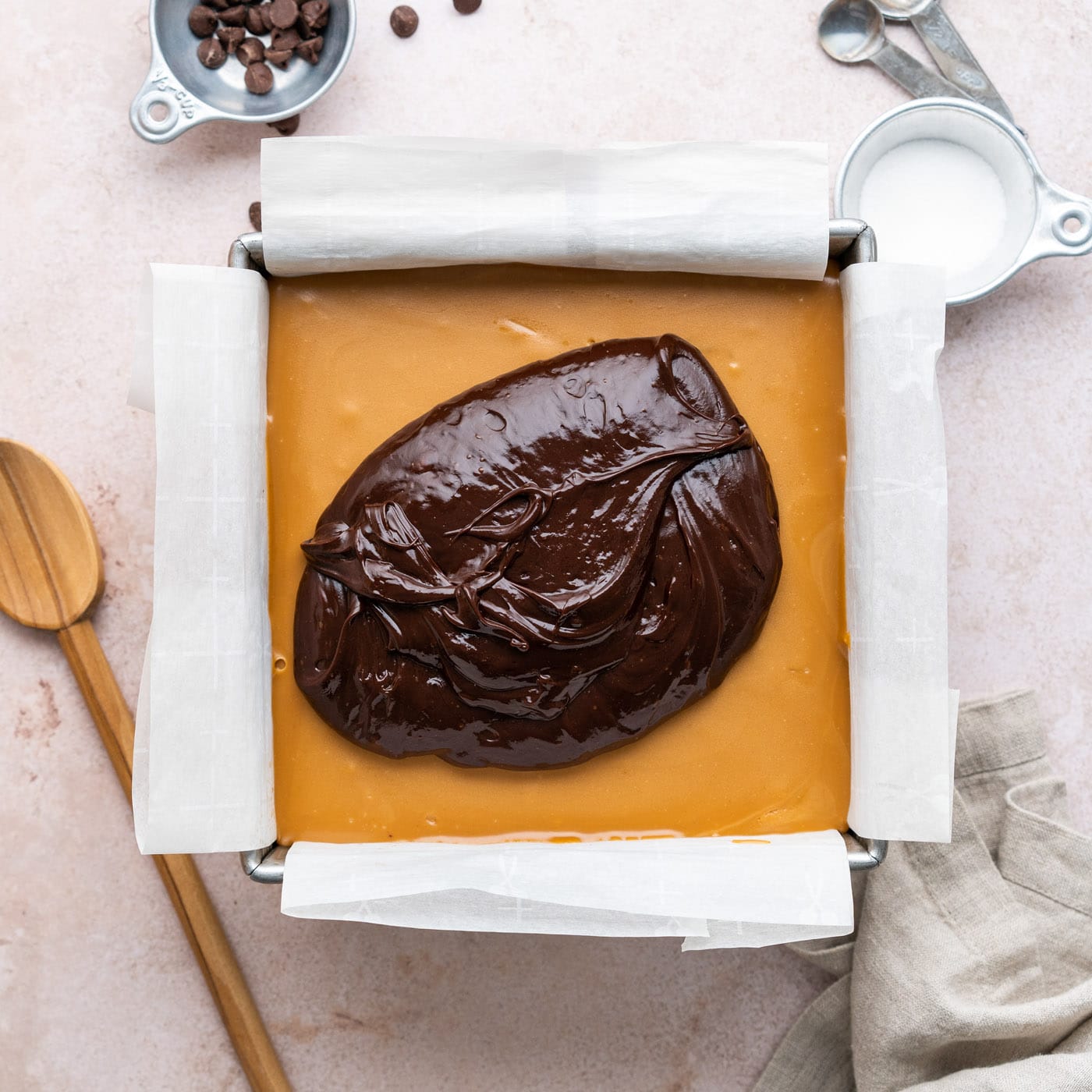 layering chocolate ganache over caramel