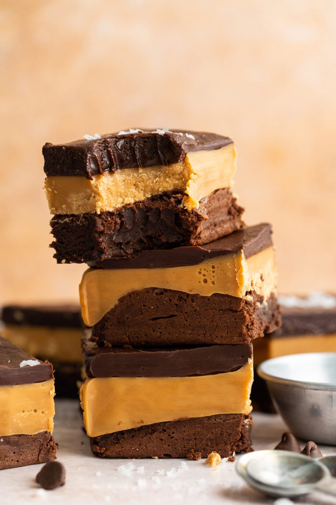 Stack of three Millionaire Brownies with a bite removed from the top one