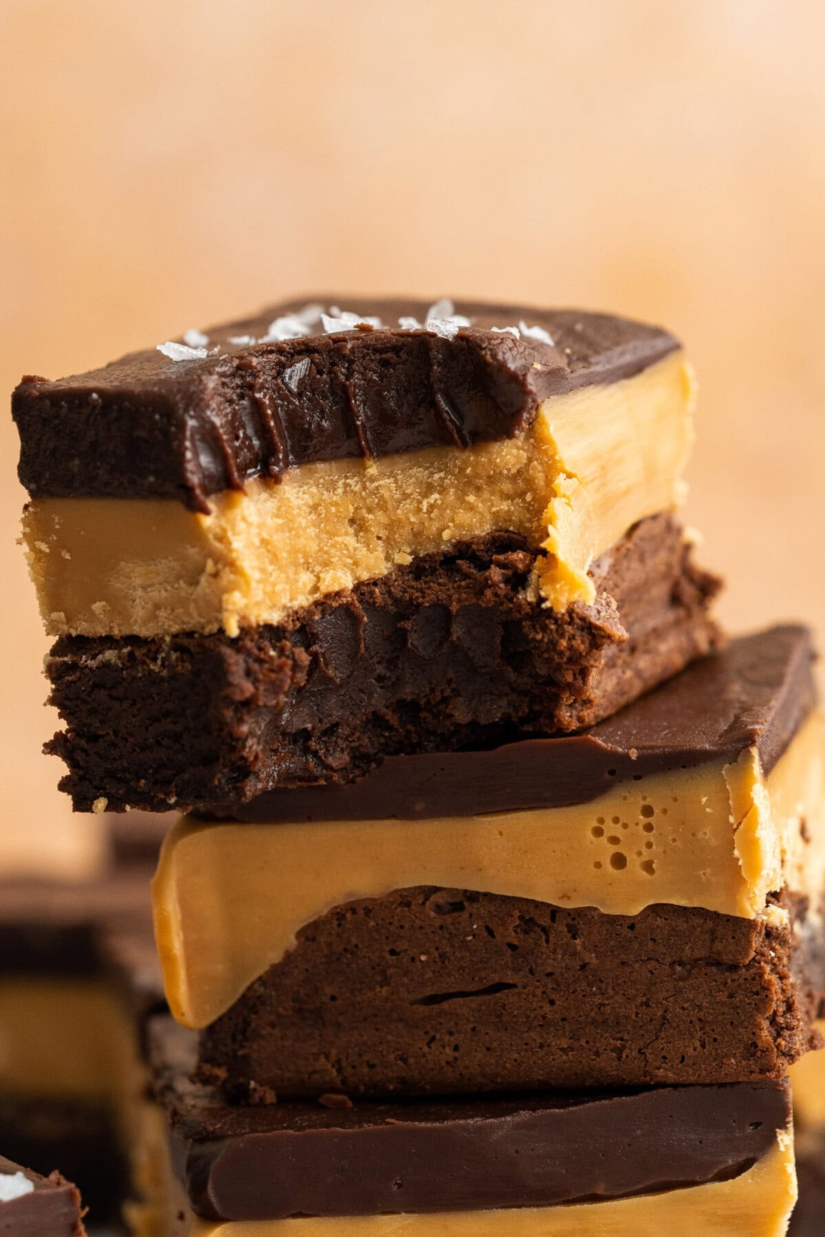 Close up photo of a Millionaire Brownie with a bite taken out
