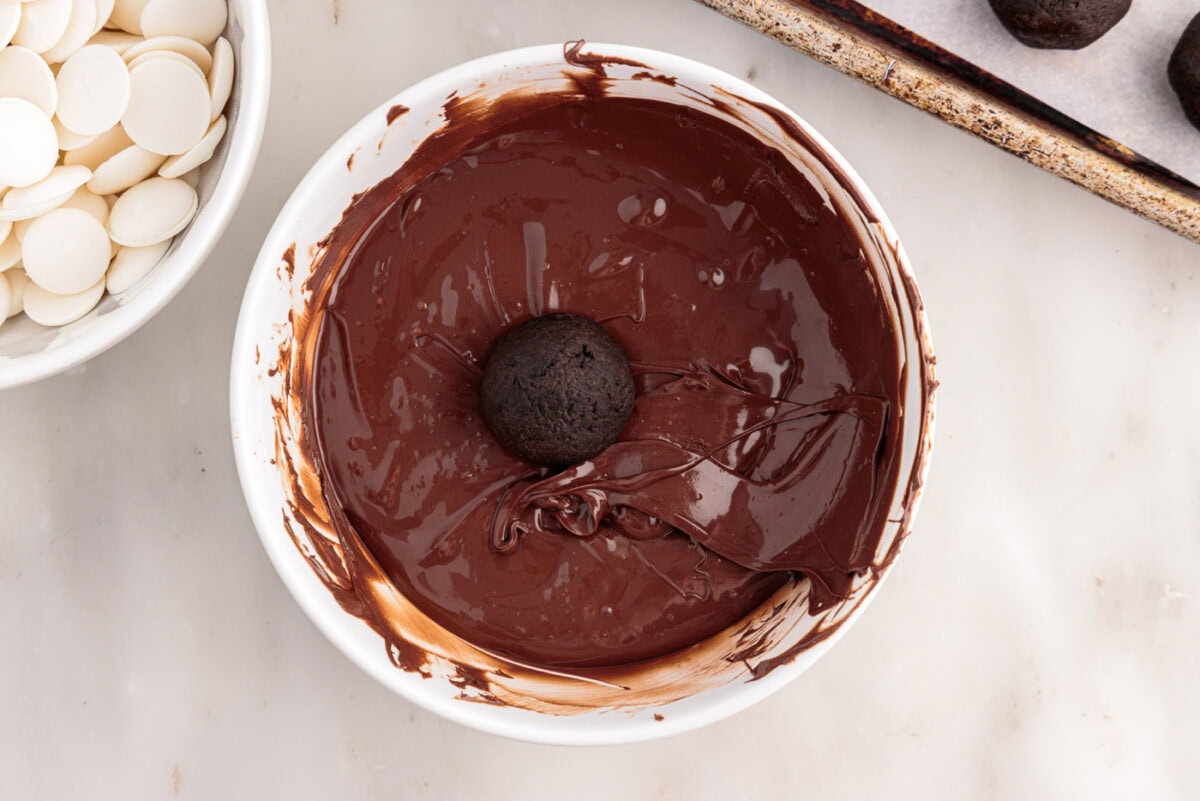 Oreo balls in a bowl of chocolate