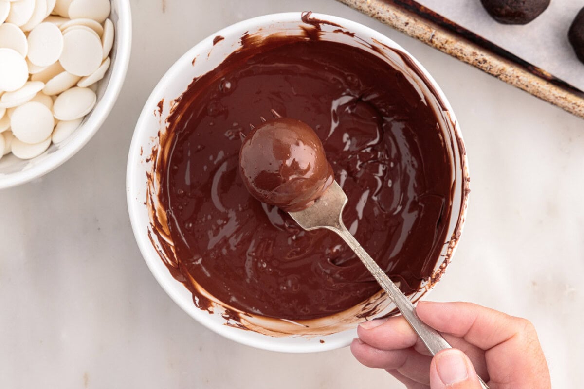 removing oreo truffles from chocolate with a fork