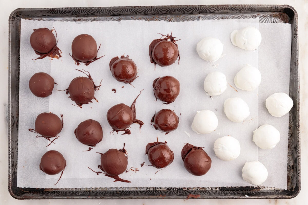 chocolate dipped oreo balls on a baking sheet