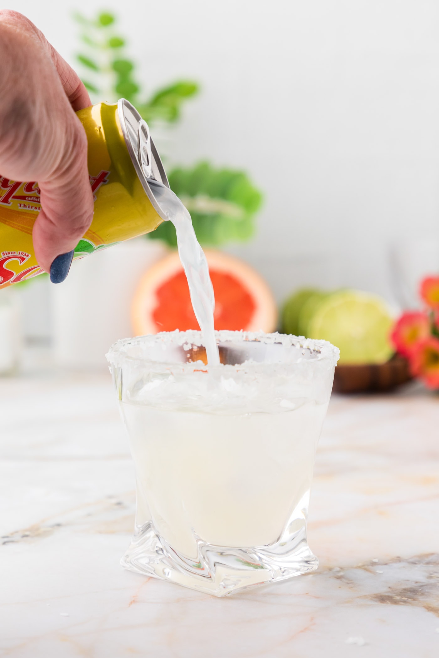adding grapefruit soda to lime juice and tequila