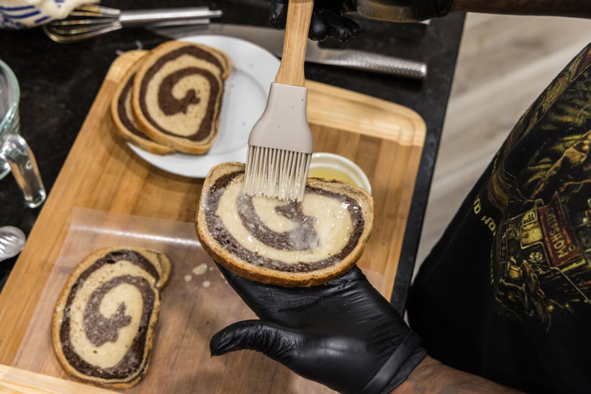 brushing butter on rye bread