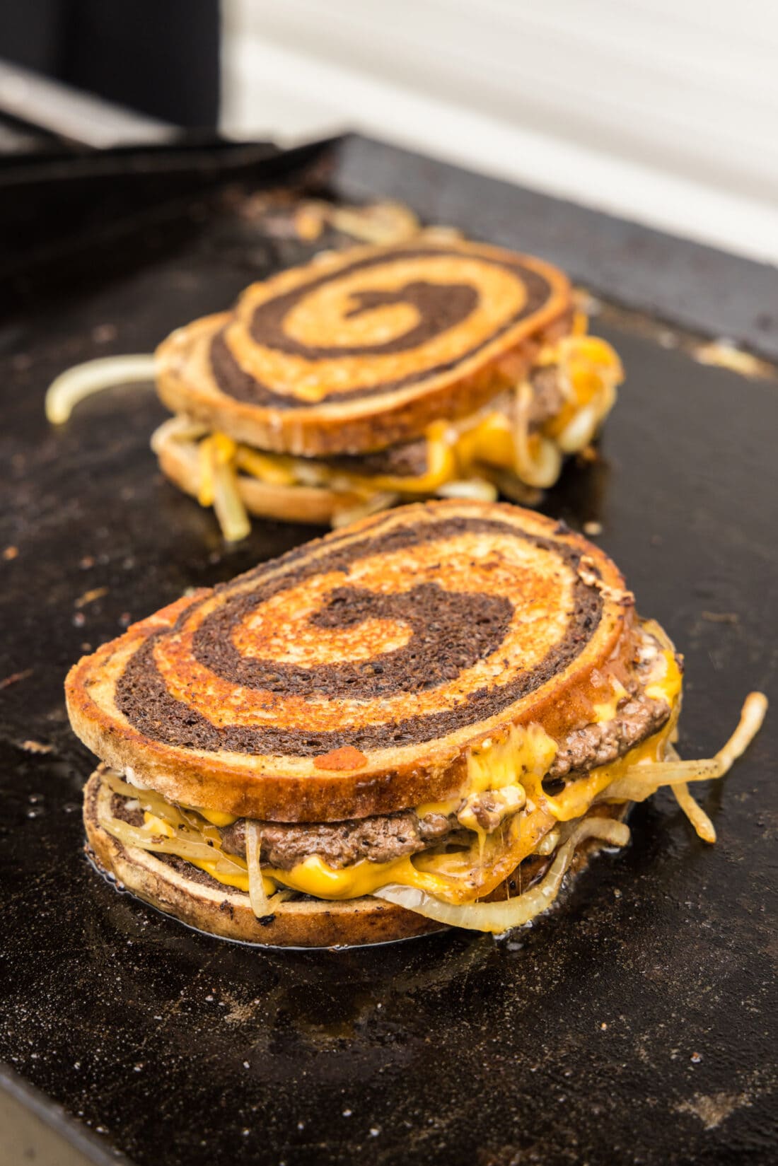 Two Patty Melts on a griddle