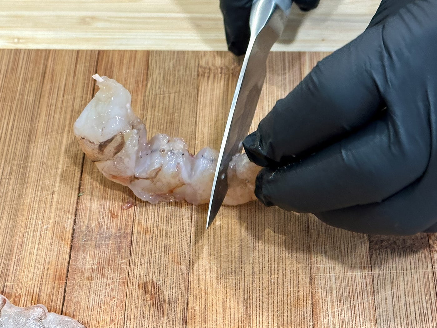 scoring shrimp with a knife