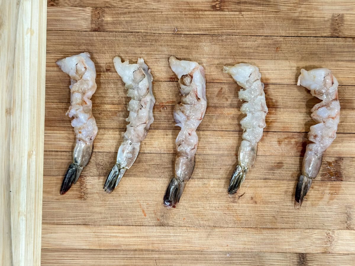 scored shrimp on a cutting board