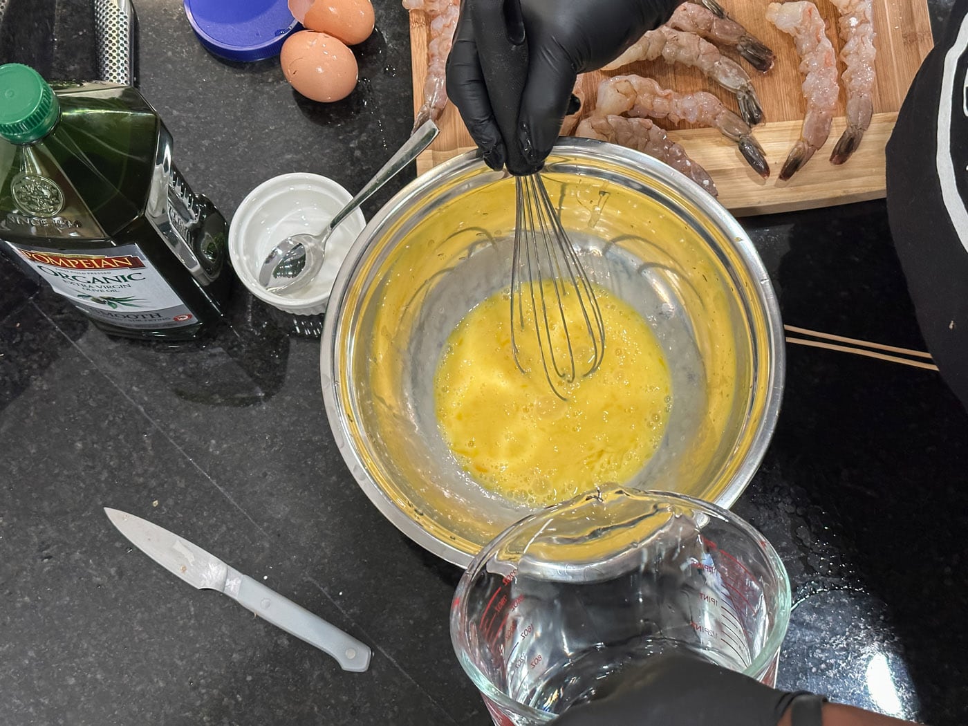 whisking eggs with water in a bowl