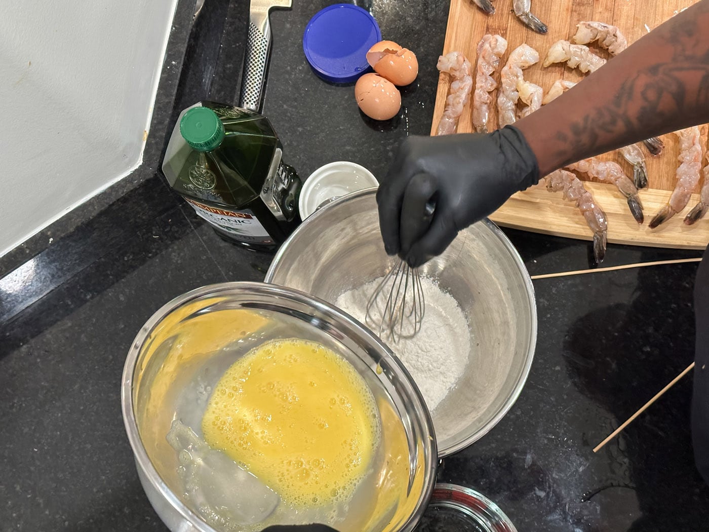 pouring whisked eggs into flour
