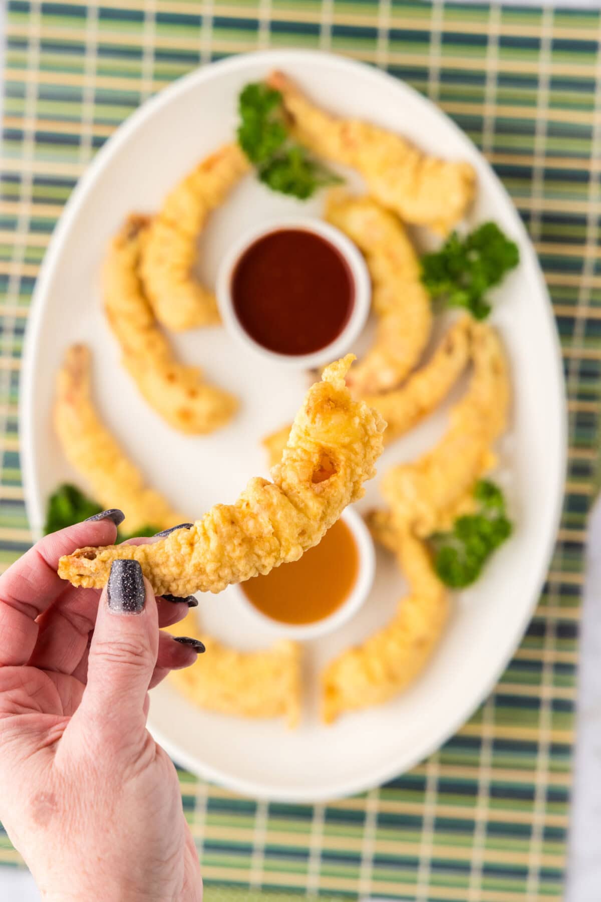 Hand holding up a Shrimp Tempura