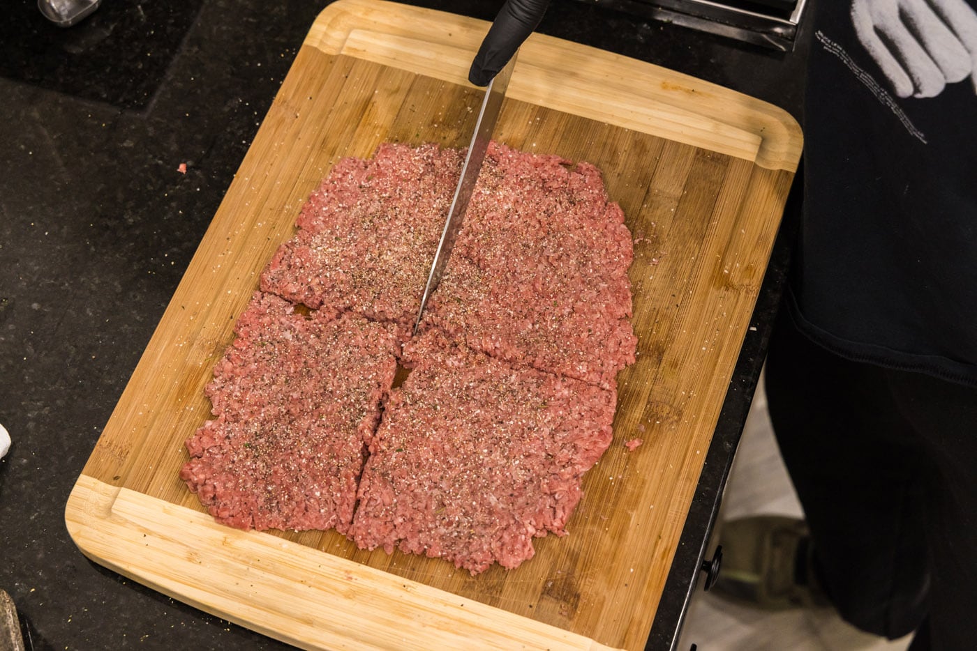 slicing ground beef into 4 sections