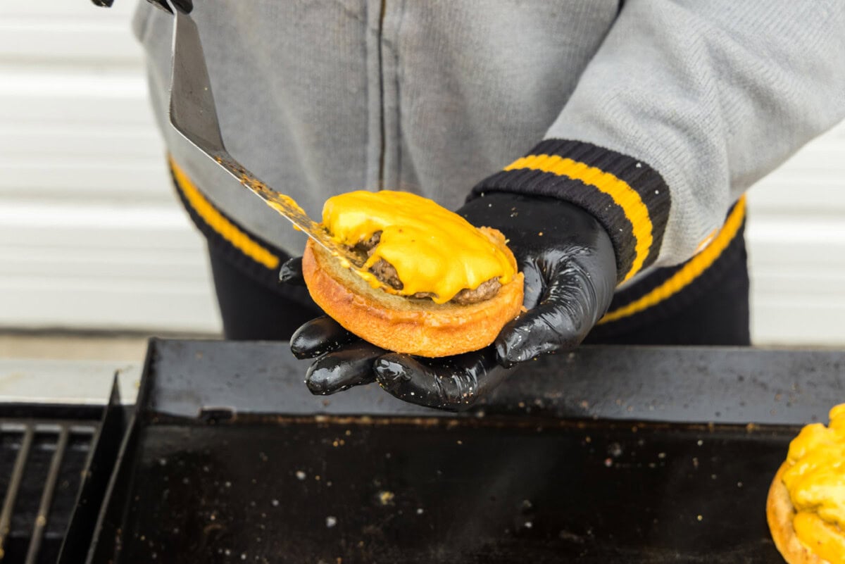 adding burger patty with cheese to a bun