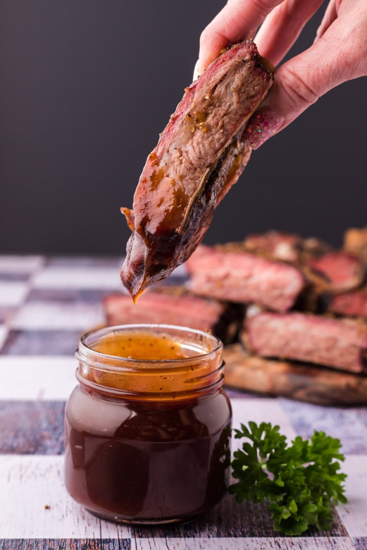 Smoked Beef Rib dipped in barbecue sauce